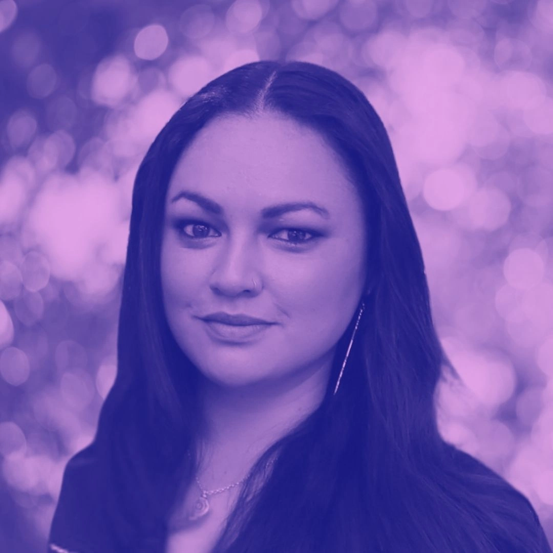 Portrait of a Beyond Animal Research co-founder with dark hair, purple colour overlay and blurred background.